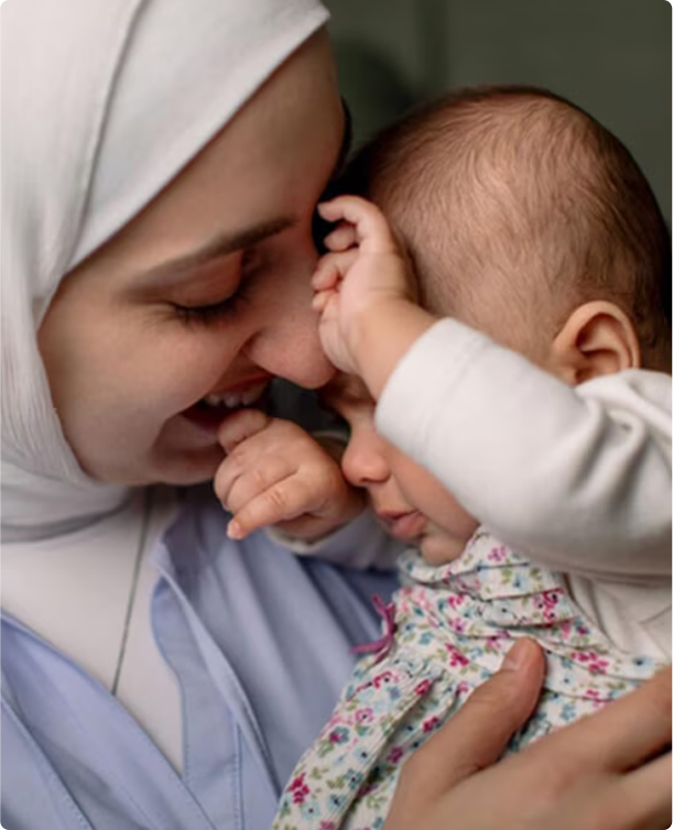 Mother holding child in a clinical care setting